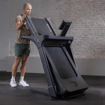 A close-up of the 10-inch touchscreen display on the Treadmill Inspire Series T4s Folding Centr, showing pre-loaded entertainment apps