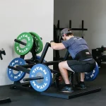 A close-up of the large diamond-plated footplate on the Lower Body Belt Squat Machine, emphasizing its non-slip traction