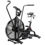 A person performing a high-intensity full-body workout on the Bike Assault AirBike, showing both arm and leg movement