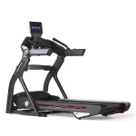 A person running on the BowFlex 10 Treadmill JRNY, showing its 10-inch adjustable HD touchscreen