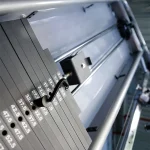 Dual Adjustable Pulley Machine A collection of the included accessories (short/long strap handles, tricep rope, sport bar, etc.) hanging on the machine's storage hangers