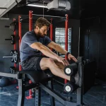 Hamstring H-PND Combo And Glute A person performing a reverse hyperextension exercise, demonstrating the machine's ability to work the lower back and posterior chain