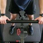 Lower Body Belt Squat Machine A detailed shot of the four weight storage posts on the rear of the unit, with Olympic plates on them