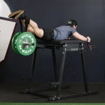 Lower Body Machines Economy H-PND A person performing a reverse hyperextension exercise, highlighting the targeted muscle groups and machine's design