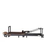 Private Pilates Foldable Metal Reformer Machine unfolded in a home studio