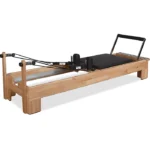 Private Pilates Wood Reformer Machine with solid timber frame and premium upholstery