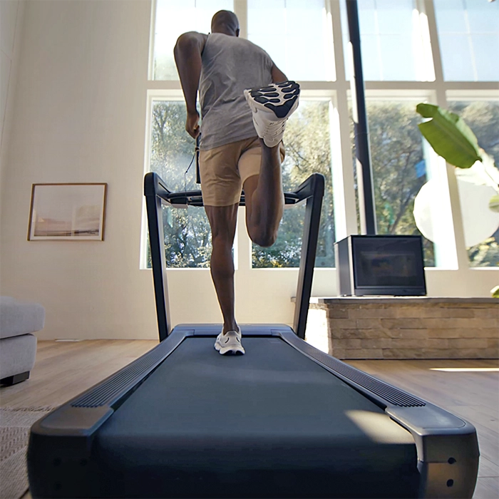 Man running on a premium treadmill in a modern home gym